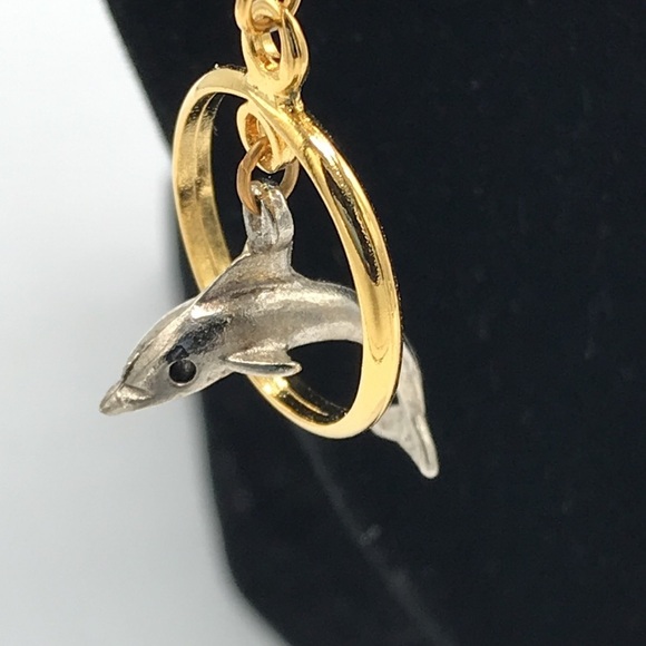 Silver tone dolphin jumping through gold tone hoop earrings - Picture 1 of 6